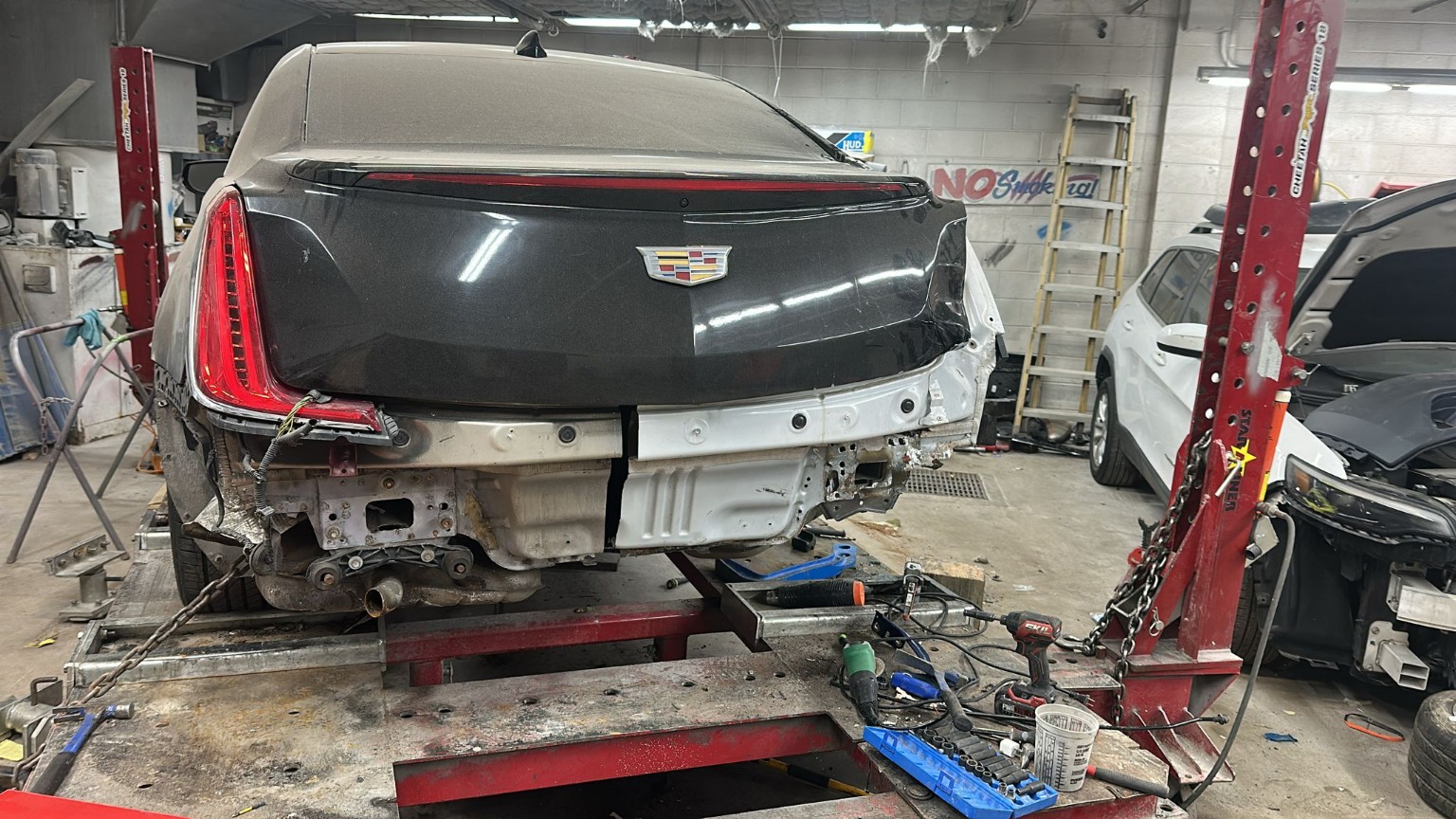 Cadillac undergoing structural collision repair
